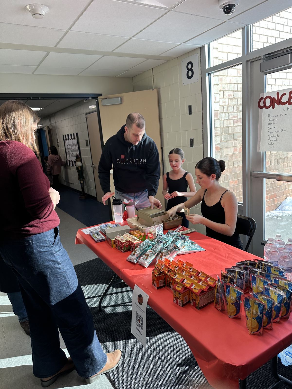 Piper running her dance studio's concession stand for the Nutcracker performance